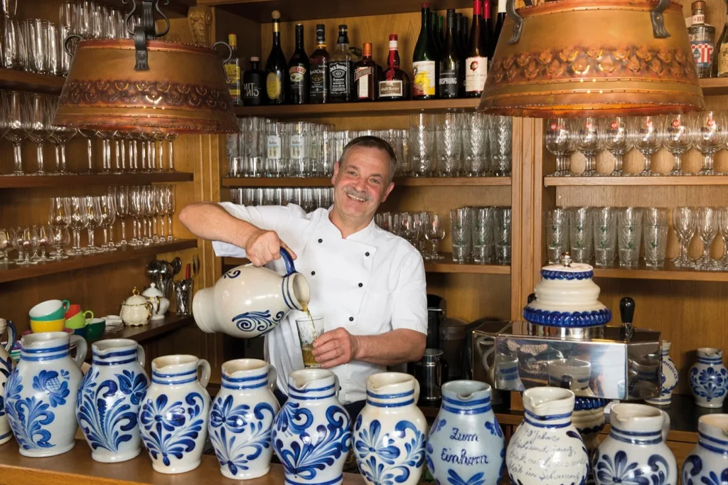 Wirt Willi Kehr schenkt Apfelwein im Gasthaus zum Einhorn ein